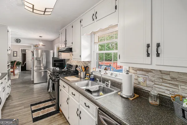a bedroom with furniture and a flat screen tv