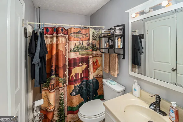a spacious bedroom with a bed and a chandelier