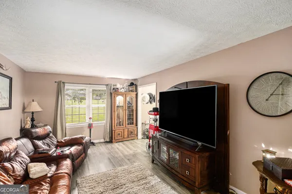 a dining room with furniture potted plants and wooden floor