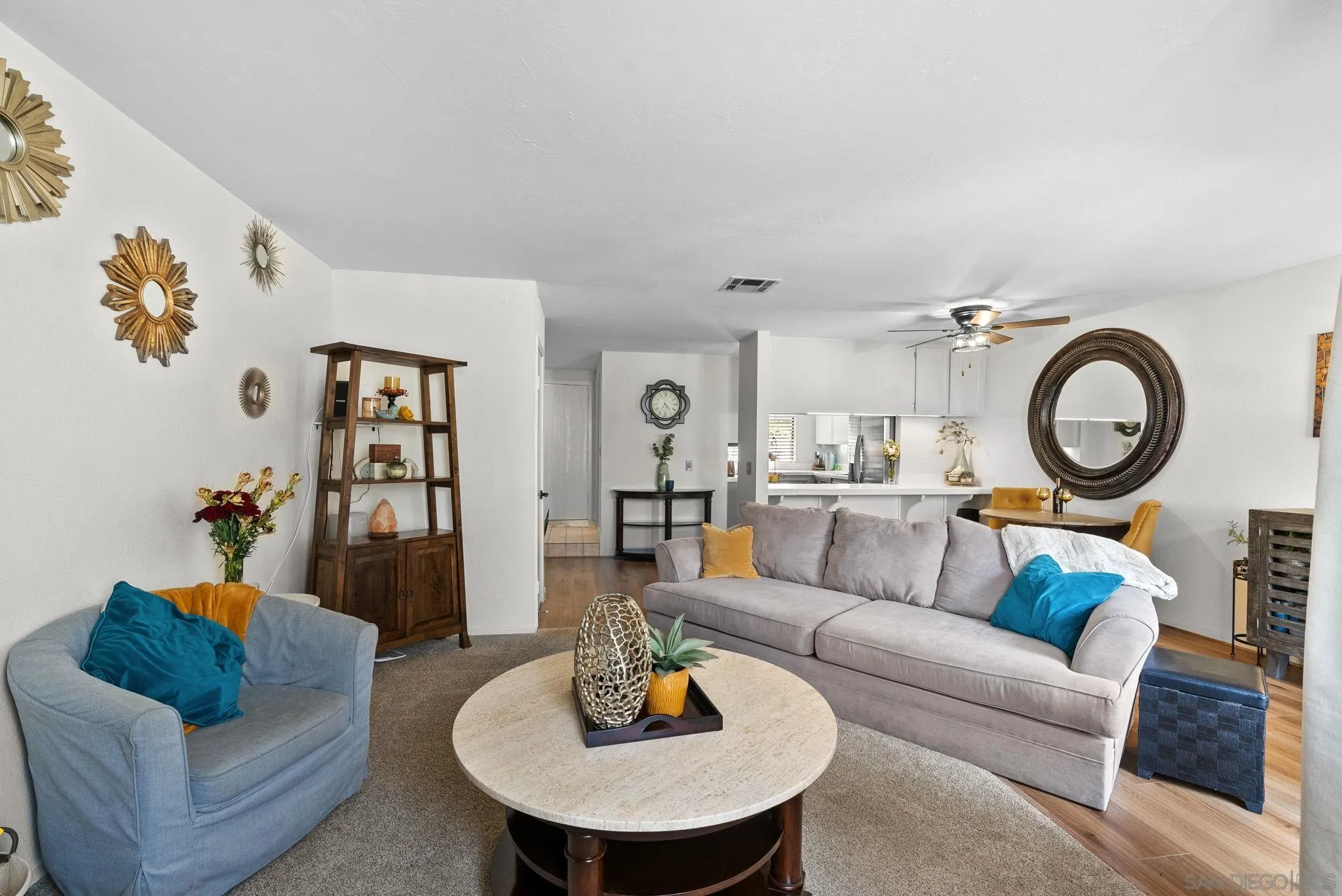a living room with furniture and a dining room