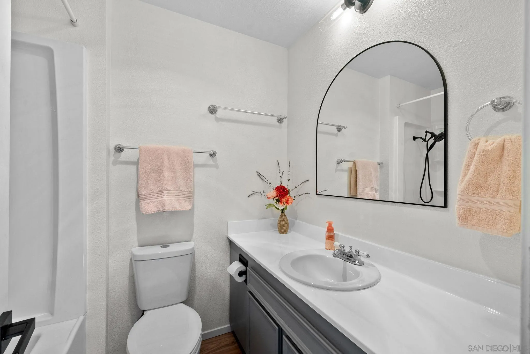 10790 Riderwood Terrace, Unit B Santee, CA 92071 - Photo 13 of 24 a bathroom with a granite countertop toilet sink and mirror