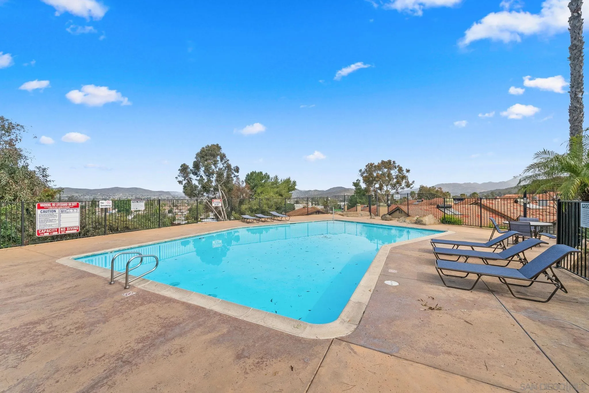 10790 Riderwood Terrace, Unit B Santee, CA 92071 - Photo 18 of 24 a view of a swimming pool with a lounge chair and couches in the patio