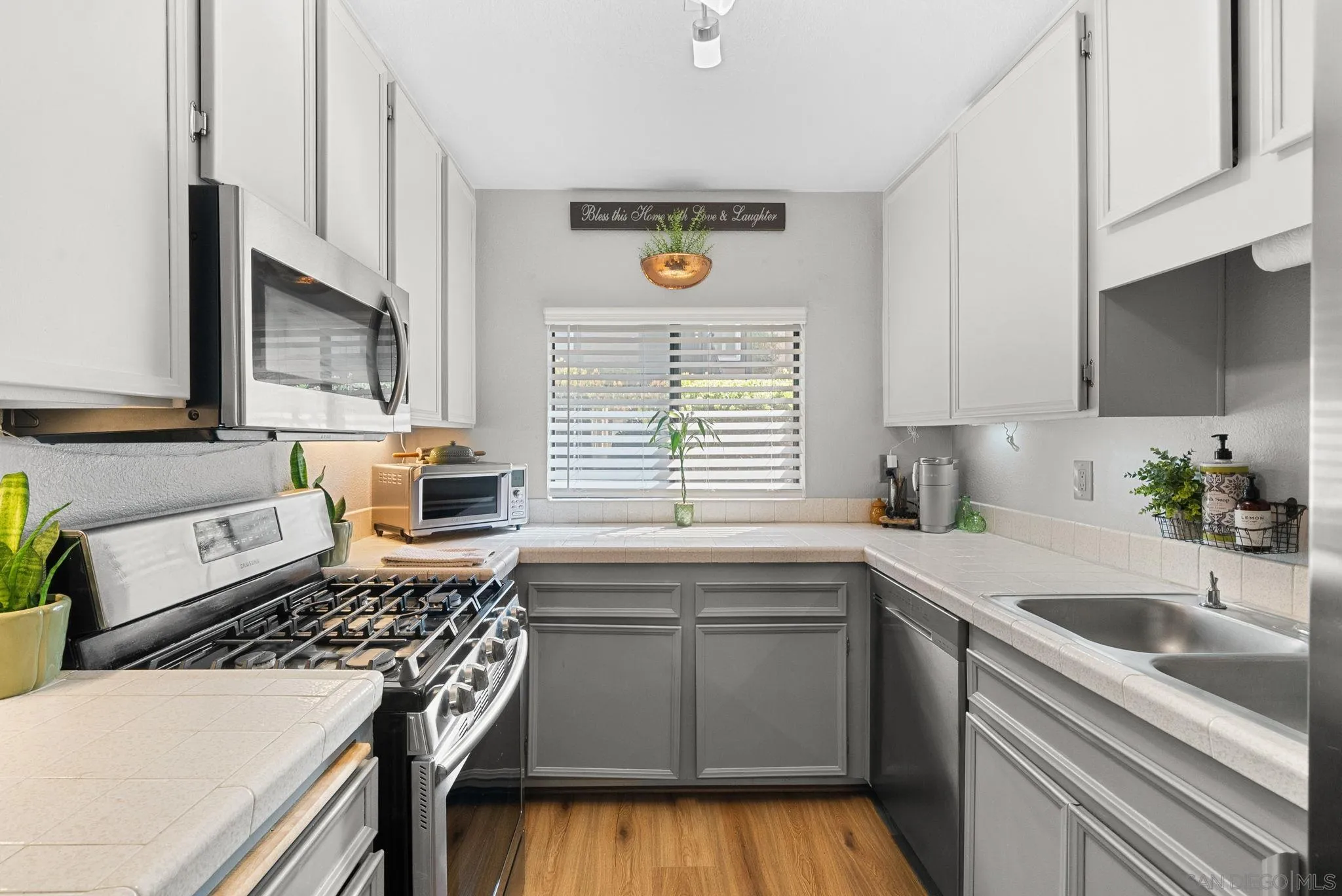 10790 Riderwood Terrace, Unit B Santee, CA 92071 - Photo 7 of 24 a kitchen with a sink stove top oven and microwave