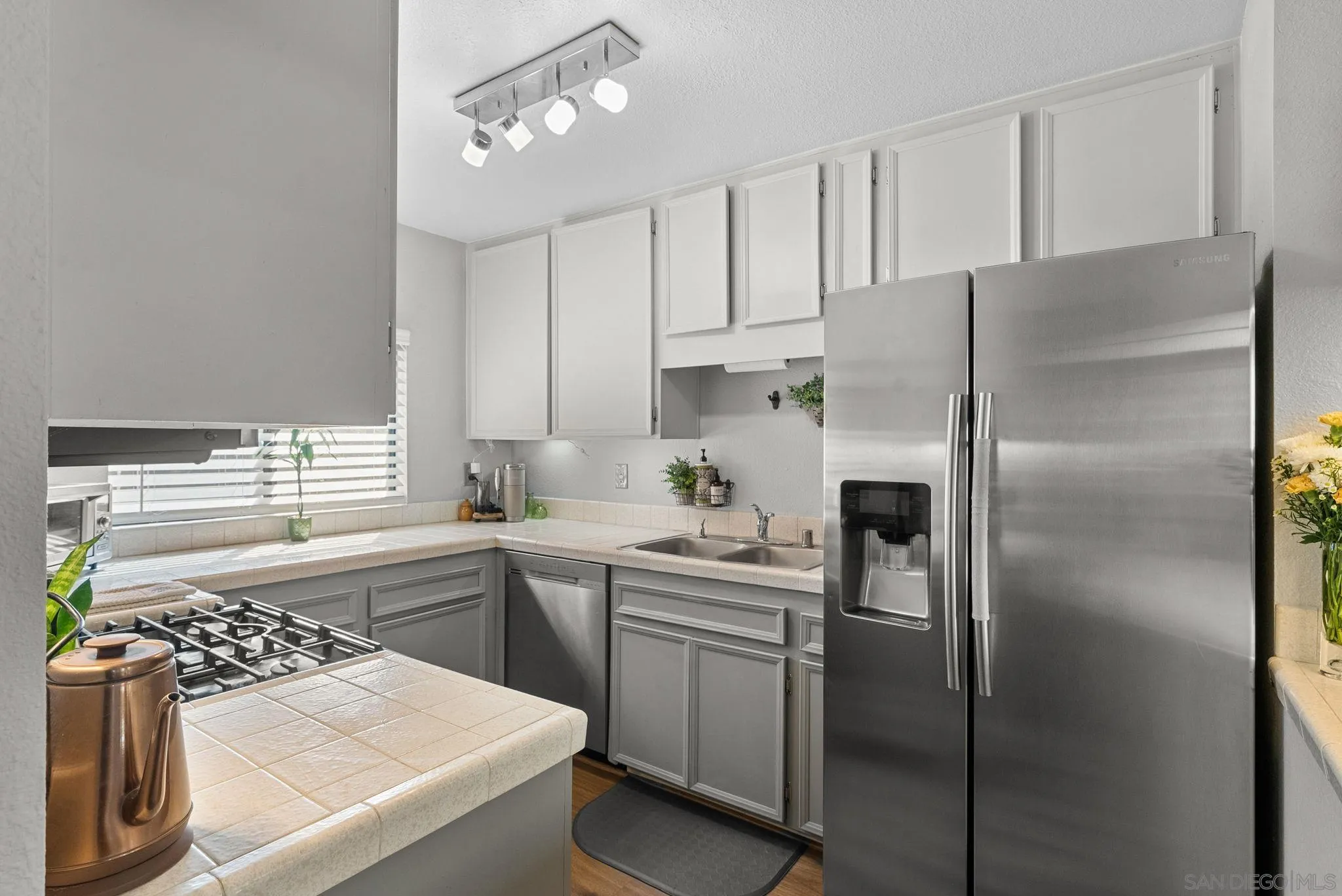10790 Riderwood Terrace, Unit B Santee, CA 92071 - Photo 9 of 24 a kitchen with a sink stainless steel appliances and cabinets
