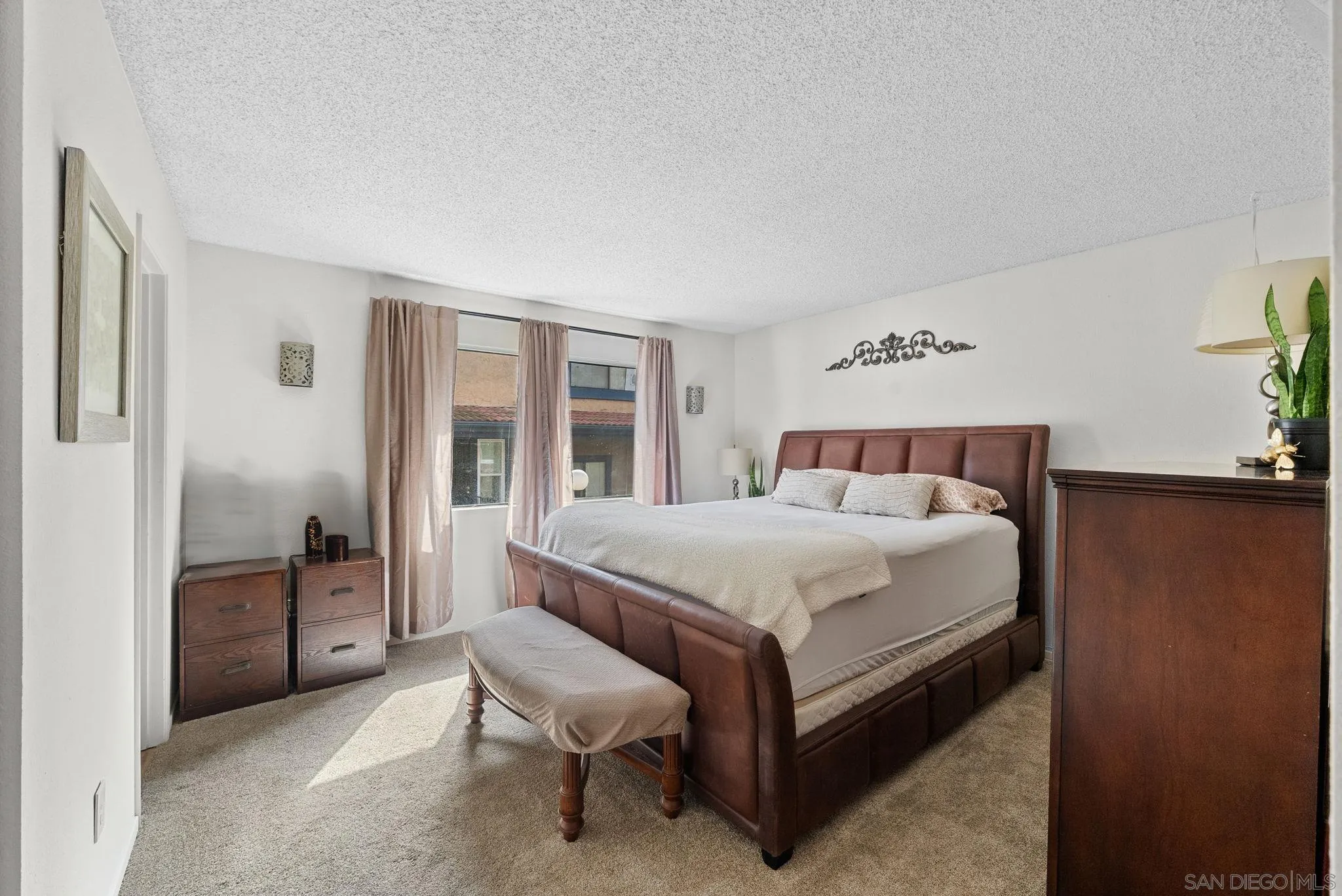10790 Riderwood Terrace, Unit B Santee, CA 92071 - Photo 10 of 24 a spacious bedroom with a bed and wooden floor