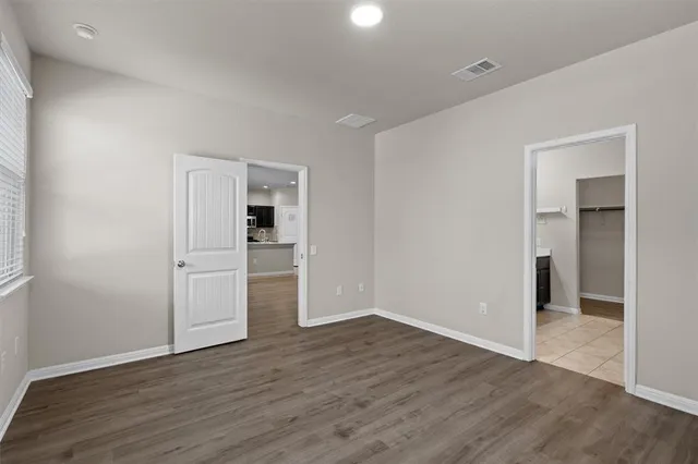 a kitchen with stainless steel appliances kitchen island granite countertop a refrigerator and a stove top oven