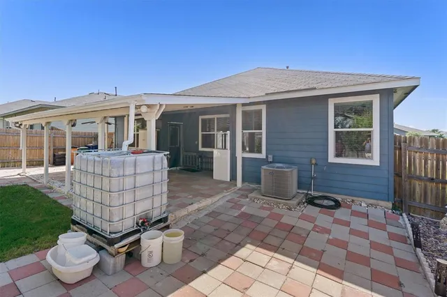a view of a patio with chairs and plants