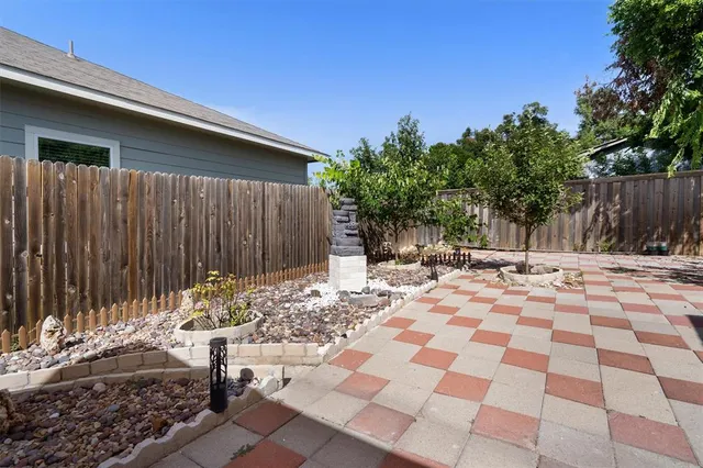 a view of a backyard with a tree