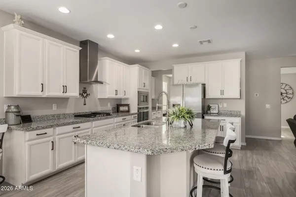 a view of a dining room with a table and chairs