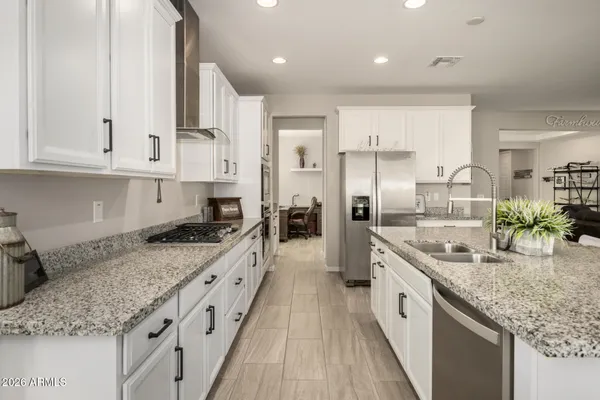 a kitchen with kitchen island granite countertop stainless steel appliances cabinets a counter top space and a center island