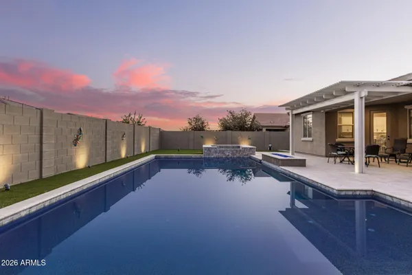 a view of a house with pool and chairs