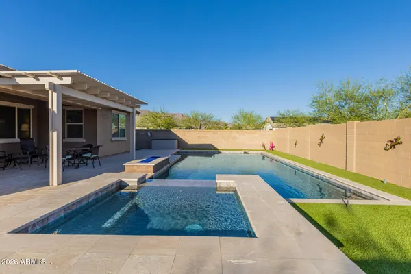 a view of a swimming pool with lounge chair