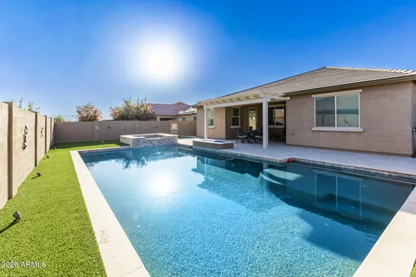 a view of a house with backyard porch and sitting area