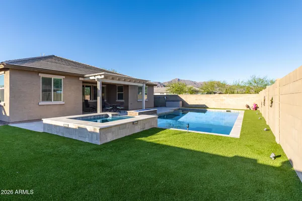 a view of a house with a yard and sitting area