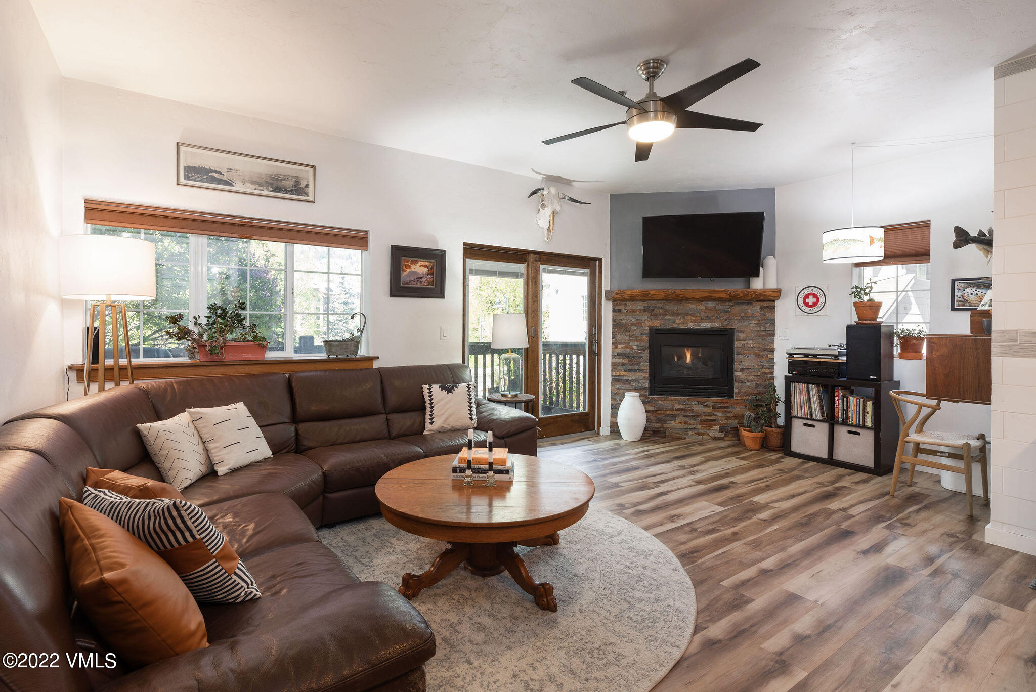 a living room with furniture a fireplace and a flat screen tv