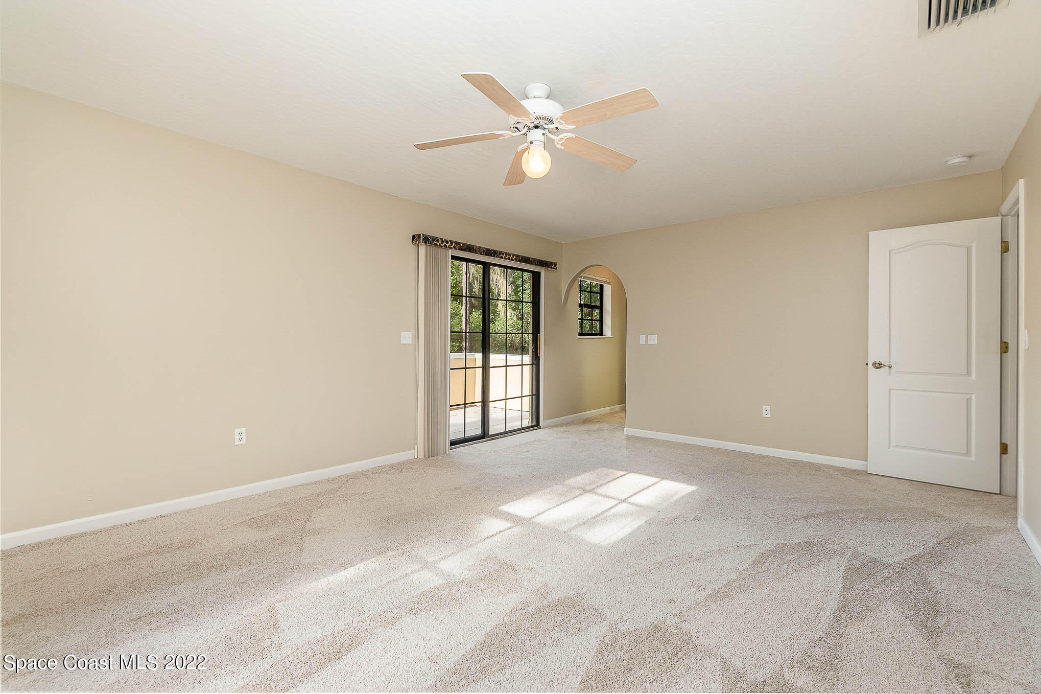 3225 Turtle Mound Road Melbourne, FL 32934 - Photo 19 of 38 a view of an empty room with a ceiling fan