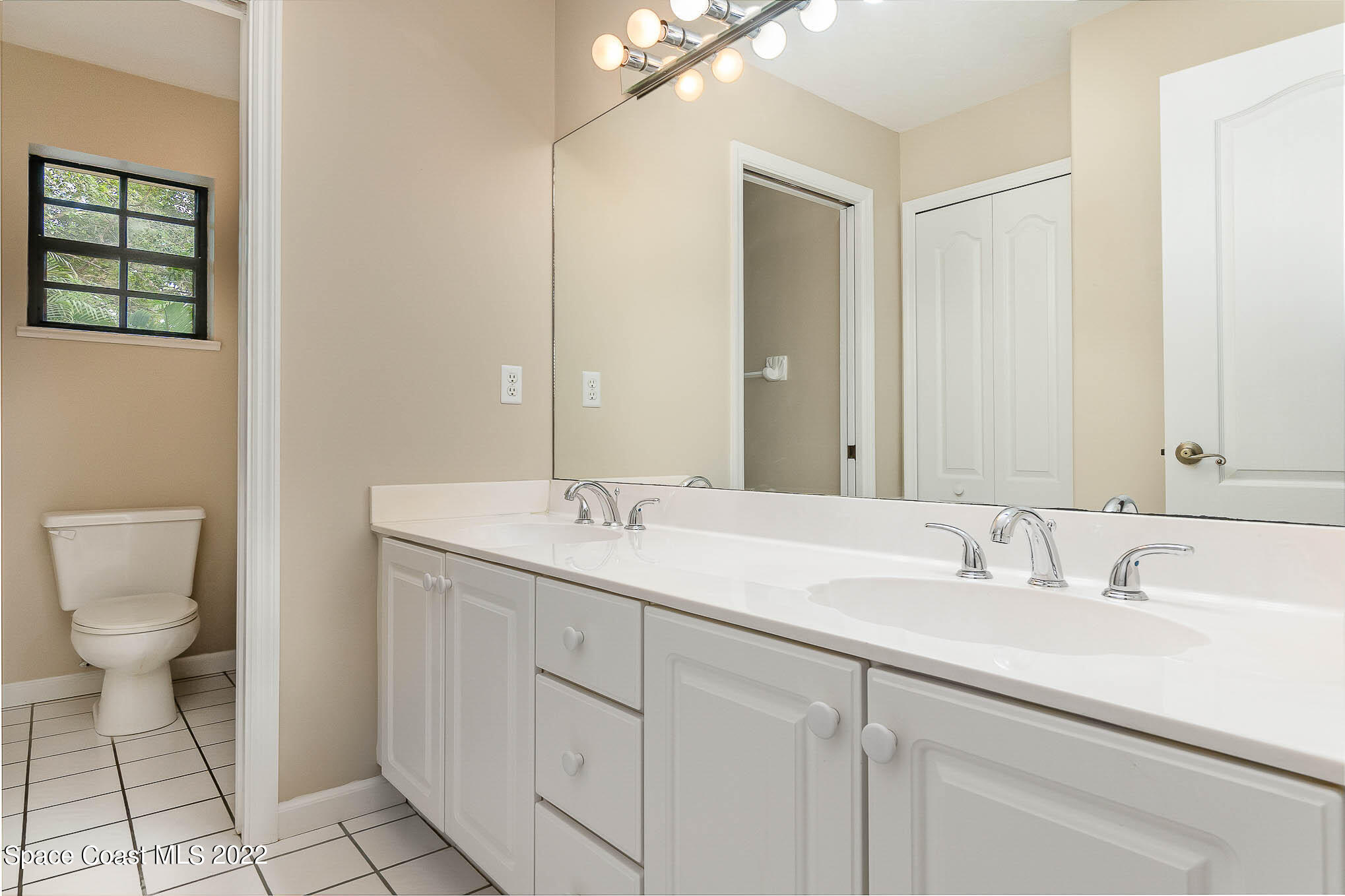 3225 Turtle Mound Road Melbourne, FL 32934 - Photo 29 of 38 a bathroom with a toilet sink and mirror