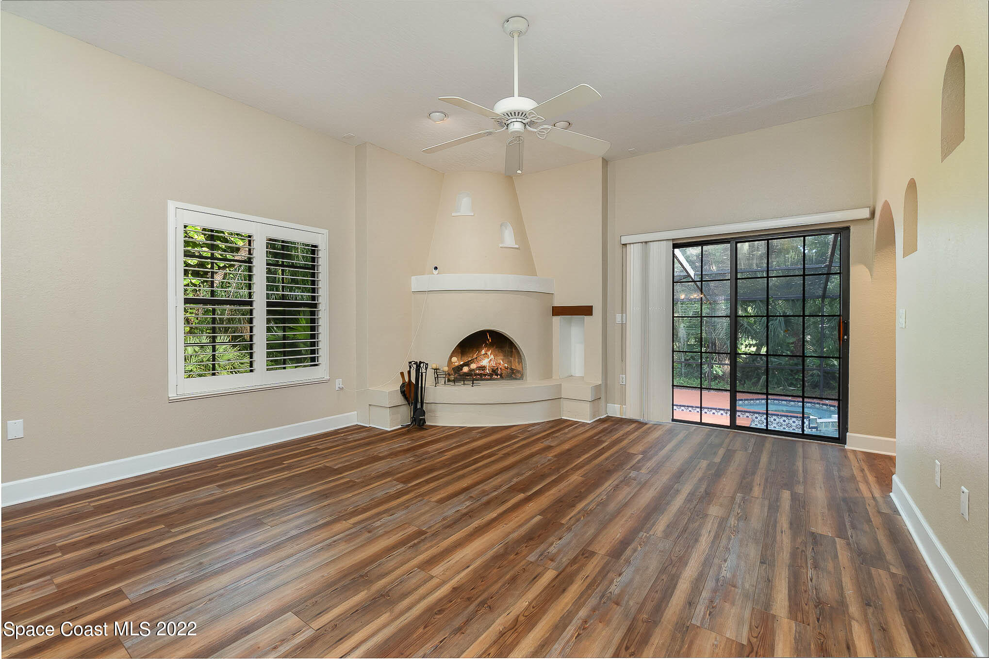 3225 Turtle Mound Road Melbourne, FL 32934 - Photo 10 of 38 a view of empty room with wooden floor and fireplace