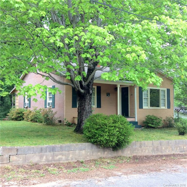 59 Beaver Street Tryon, NC 28782 - Photo 1 of 14 a front view of a house with a garden