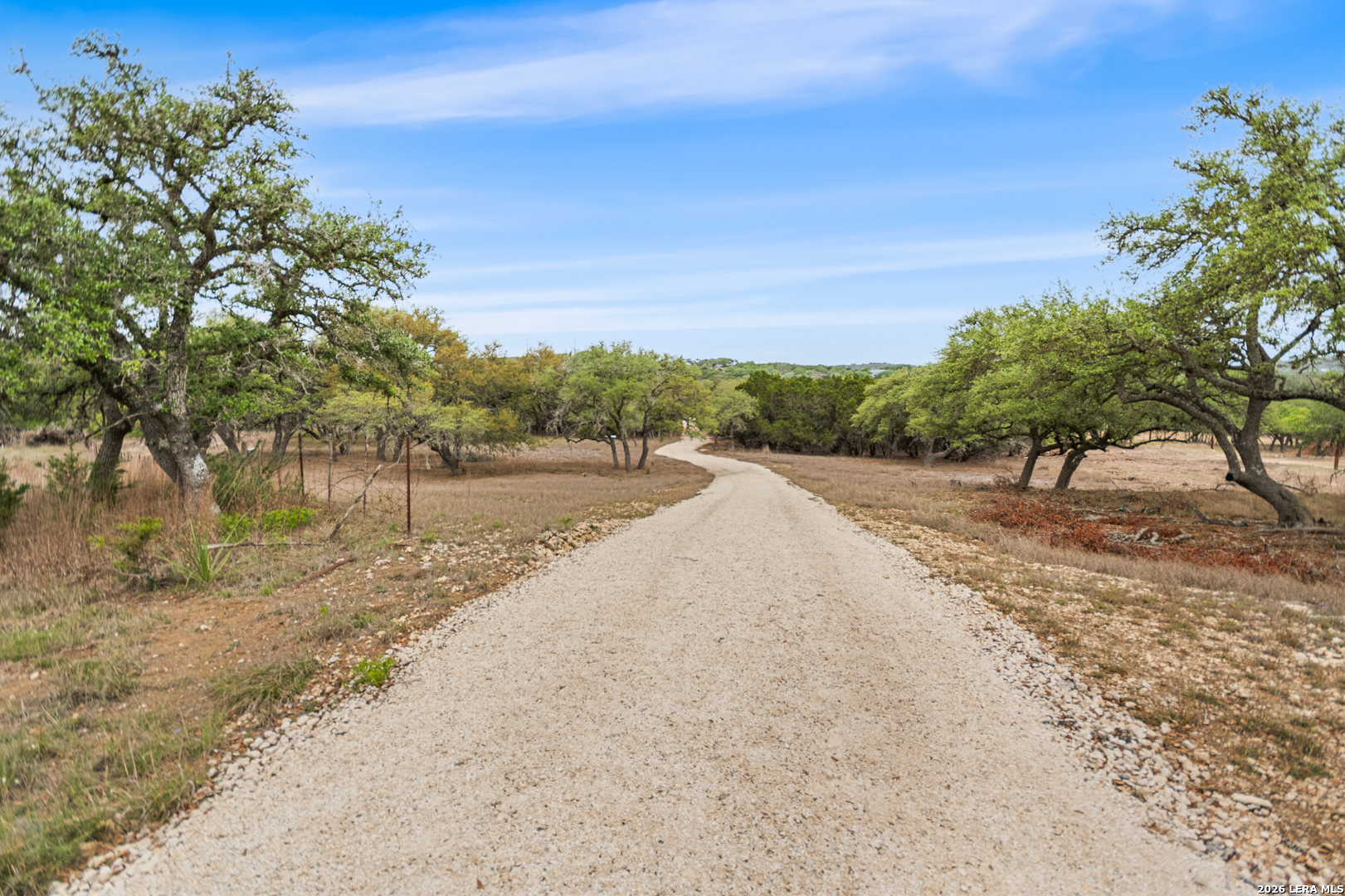 10205 2 Johns Road Boerne, TX 78006 - Photo 22 of 32 a view of a dirt road with trees in the background