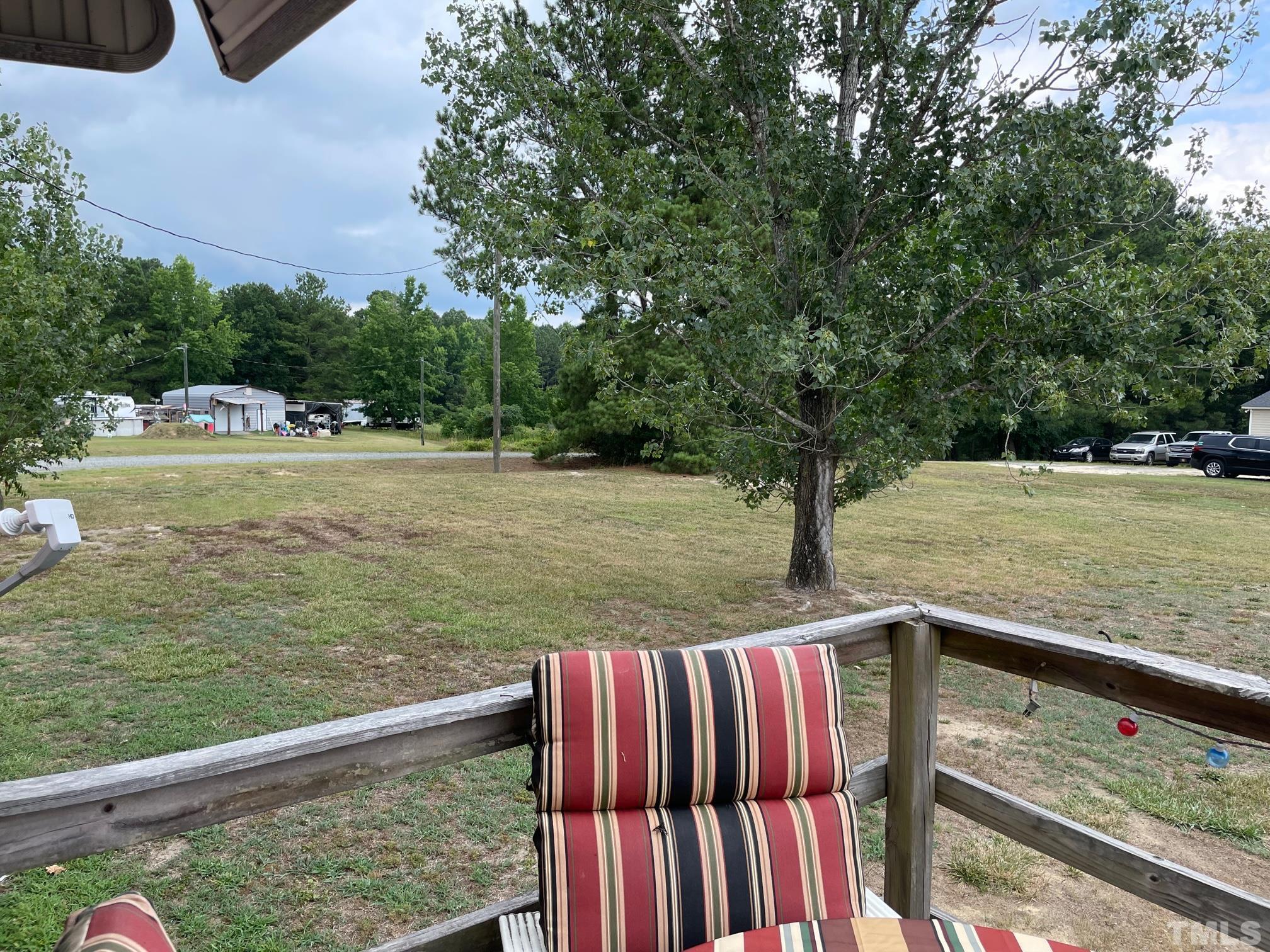 1616 Pope Road Creedmoor, NC 27522 - Photo 36 of 42 a view of deck and lake with trees in the background