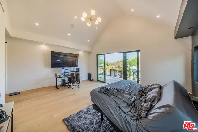 a living room with furniture a flat screen tv and a large window
