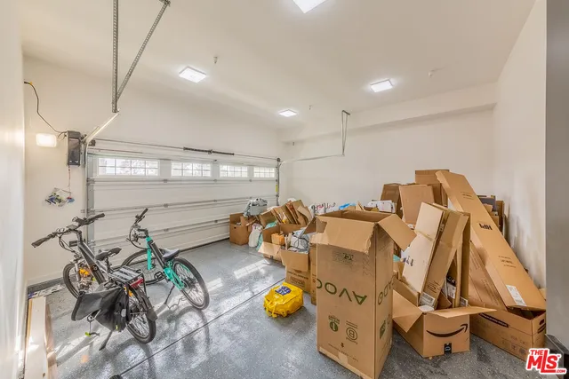 a bathroom with a sink mirror and wooden floor