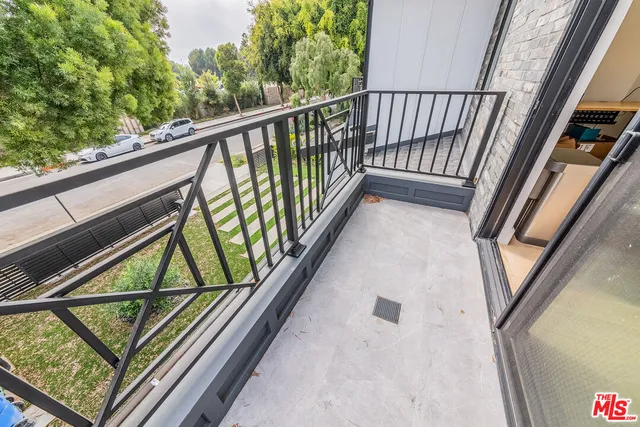 a view of walk in closet with clothes