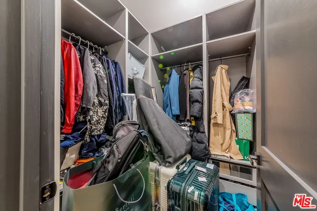 a bedroom with a bed and a wooden floor