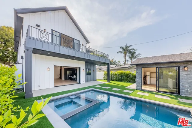 a view of backyard with barbeque grill and wooden fence