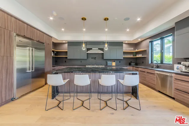 a large kitchen with a table and chairs