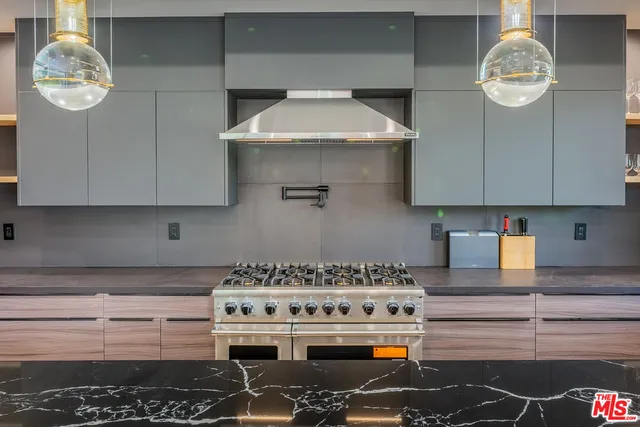 a stove top oven sitting inside of a kitchen
