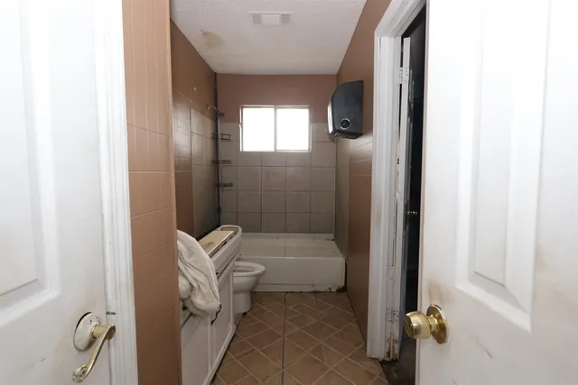 a bathroom with a tub and shower