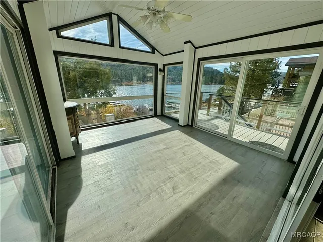 a view of a porch with furniture and floor to ceiling window