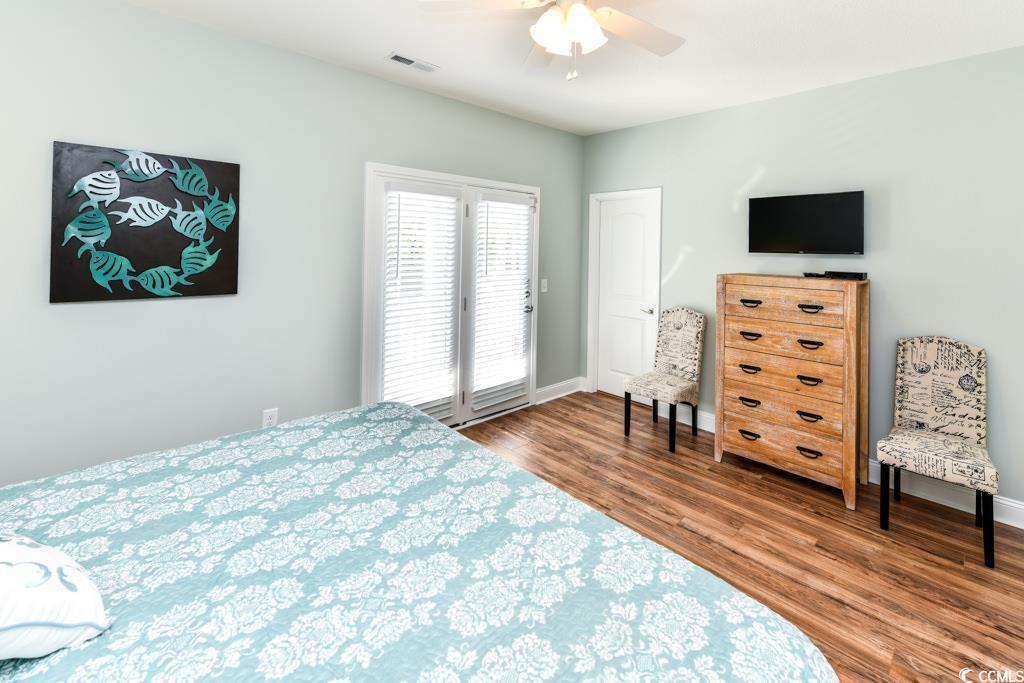 1614 North Ocean Boulevard Surfside Beach, SC 29575 - Photo 12 of 38 Bedroom with visible vents, baseboards, wood finished floors, and access to outside