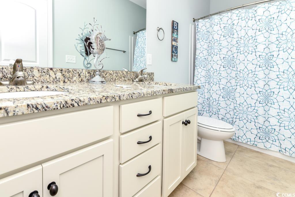 1614 North Ocean Boulevard Surfside Beach, SC 29575 - Photo 13 of 38 Bathroom with double vanity, toilet, tile patterned floors, and a sink