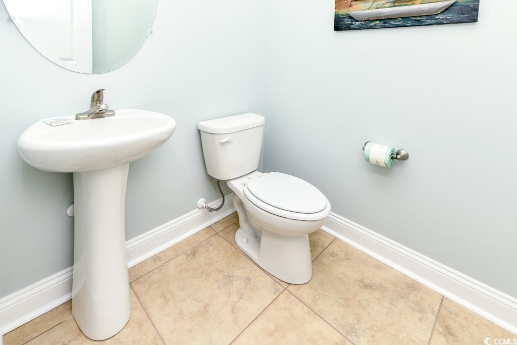 1614 North Ocean Boulevard Surfside Beach, SC 29575 - Photo 14 of 38 Bathroom featuring tile patterned flooring, toilet, baseboards, and a sink