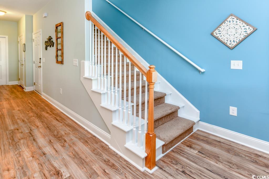 1614 North Ocean Boulevard Surfside Beach, SC 29575 - Photo 15 of 38 Stairs featuring wood finished floors and baseboards