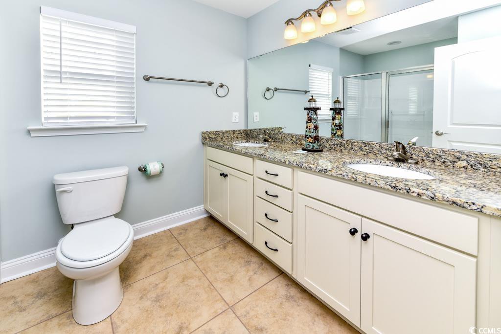 1614 North Ocean Boulevard Surfside Beach, SC 29575 - Photo 18 of 38 Bathroom with a sink, toilet, a shower stall, and tile patterned flooring