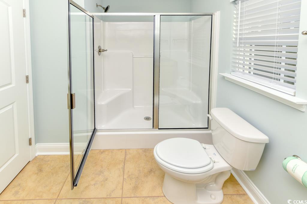 1614 North Ocean Boulevard Surfside Beach, SC 29575 - Photo 19 of 38 Full bath with tile patterned floors, baseboards, toilet, and a stall shower