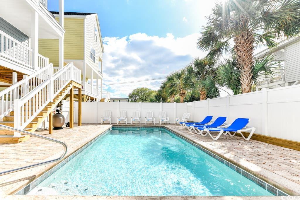 1614 North Ocean Boulevard Surfside Beach, SC 29575 - Photo 2 of 38 View of pool with a fenced in pool, stairway, a fenced backyard, and a patio area