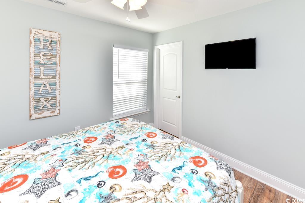 1614 North Ocean Boulevard Surfside Beach, SC 29575 - Photo 21 of 38 Unfurnished bedroom with ceiling fan, baseboards, and wood finished floors