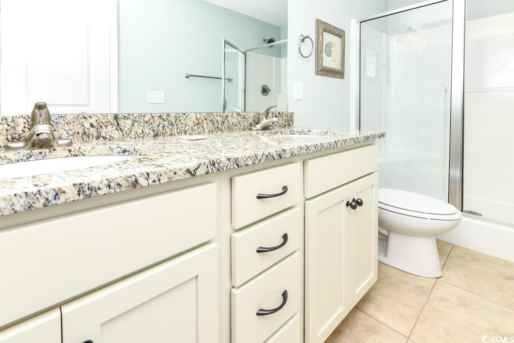 1614 North Ocean Boulevard Surfside Beach, SC 29575 - Photo 22 of 38 Bathroom featuring a sink, a shower stall, and tile patterned floors
