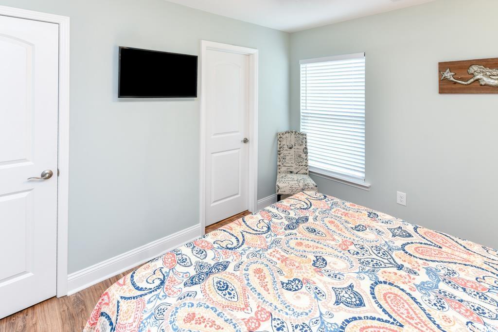 1614 North Ocean Boulevard Surfside Beach, SC 29575 - Photo 25 of 38 Bedroom featuring baseboards and wood finished floors