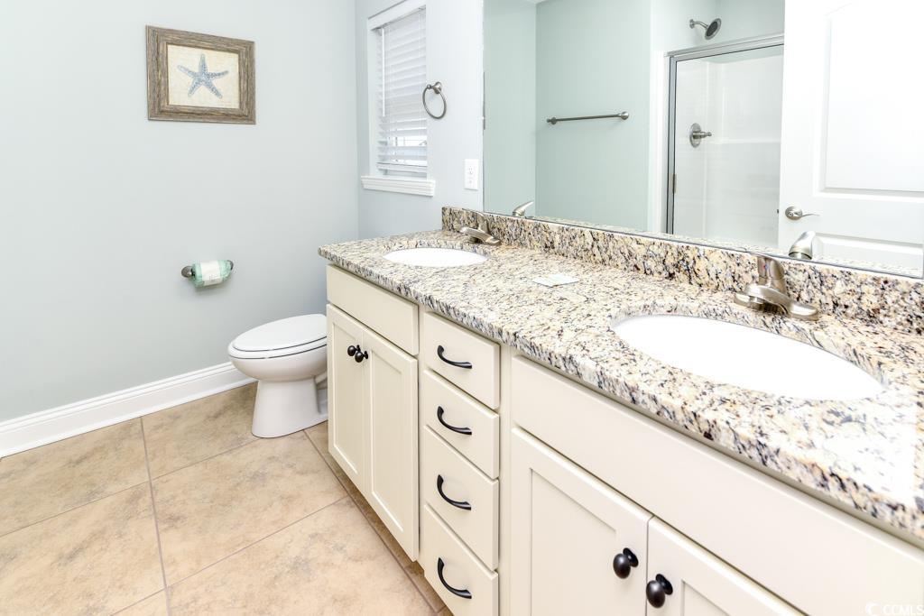 1614 North Ocean Boulevard Surfside Beach, SC 29575 - Photo 26 of 38 Full bathroom with a sink, a shower with shower door, toilet, and tile patterned flooring