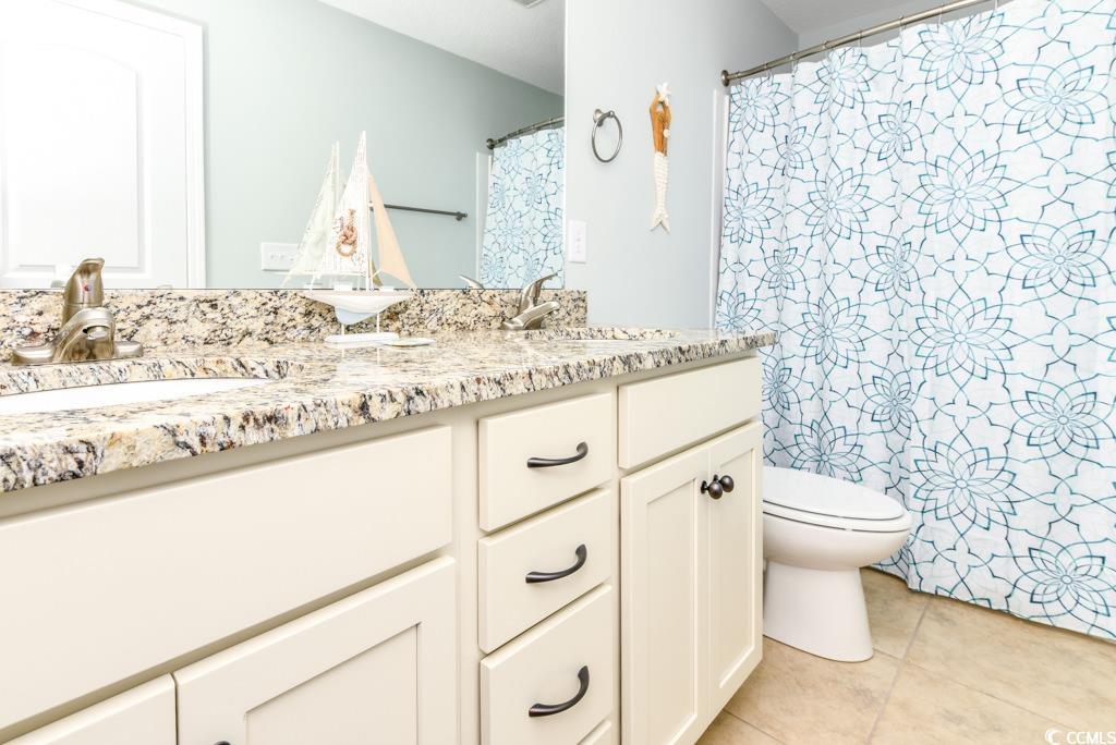 1614 North Ocean Boulevard Surfside Beach, SC 29575 - Photo 34 of 38 Bathroom featuring tile patterned floors, double vanity, toilet, and a sink