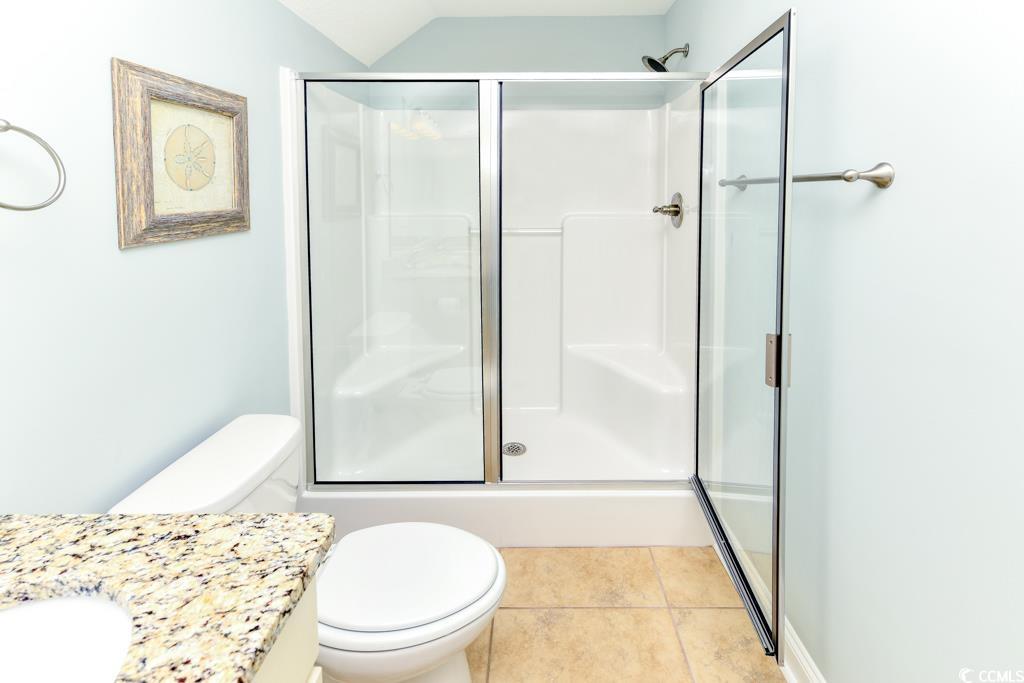 1614 North Ocean Boulevard Surfside Beach, SC 29575 - Photo 35 of 38 Full bath featuring tile patterned flooring, a stall shower, toilet, and vanity
