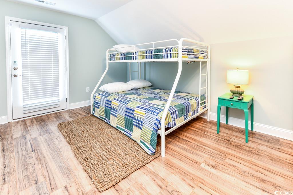 1614 North Ocean Boulevard Surfside Beach, SC 29575 - Photo 36 of 38 Bedroom featuring lofted ceiling, wood finished floors, baseboards, and visible vents