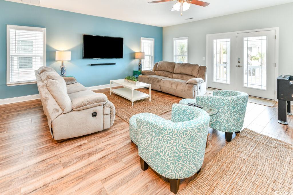 1614 North Ocean Boulevard Surfside Beach, SC 29575 - Photo 8 of 38 Living room featuring ceiling fan, visible vents, baseboards, and wood finished floors