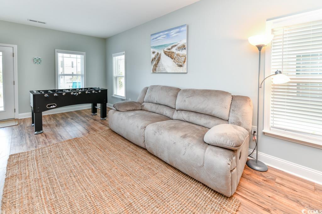 1614 North Ocean Boulevard Surfside Beach, SC 29575 - Photo 9 of 38 Living area featuring visible vents, baseboards, and wood finished floors
